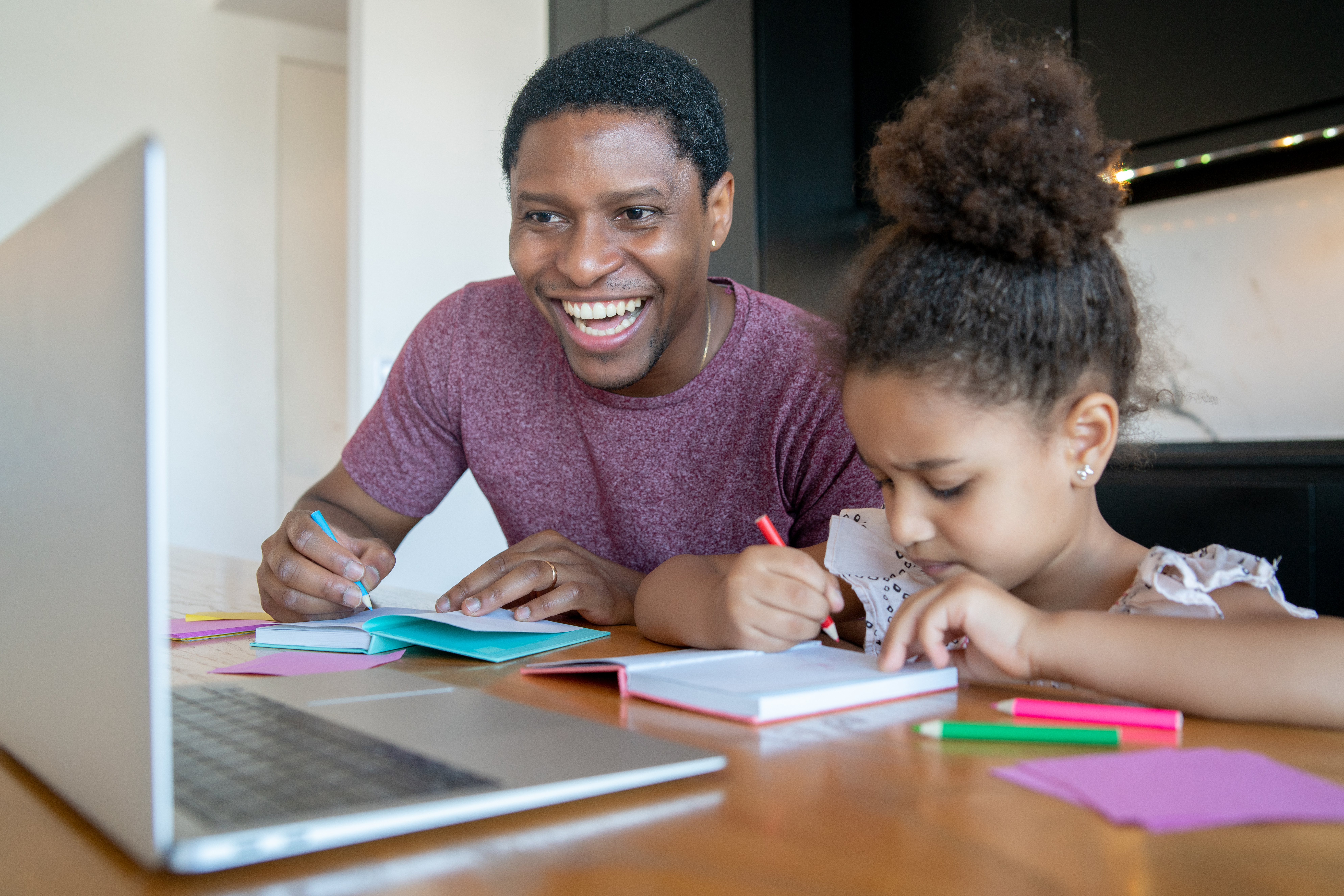 Parent helping child with online school